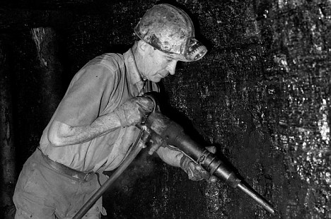 Miner cutting coal underground at Blaencuffin coal mine a privately owned drift mine on mountainside above Pontypool South Wales